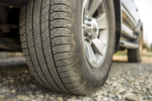 close-up of car tire on gravel road