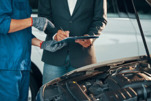 auto mechanic explaining car repairs to customer