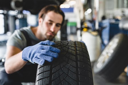 Fresno mechanic inspecting a tire during a rotation service
