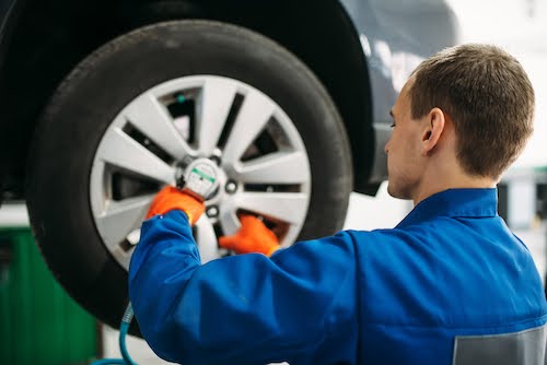 Fresno mechanic working on a tire rotation service